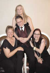 The four New Exploits authors with Szymanski, the butch, on a chair in the middle, surrounded by the four femmes: Kallmaker, Johnson and Watts.